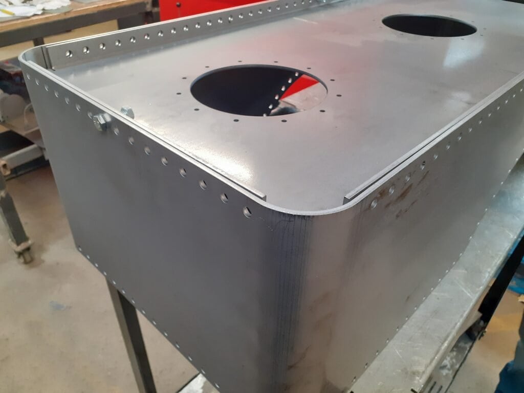 Laser cut and step bent mild steel part for traction engine tank